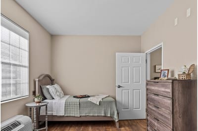Private resident bedroom with warm decor and natural light