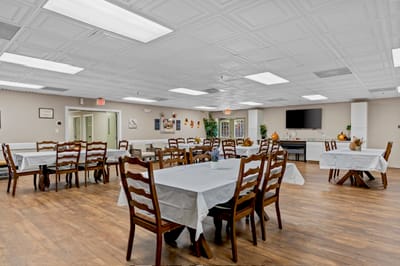 Bright dining room with tables set for residents