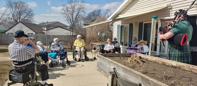 Residents enjoying a performance outdoors in the garden
