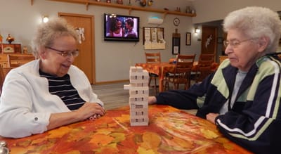 Two residents playing a game in a common area