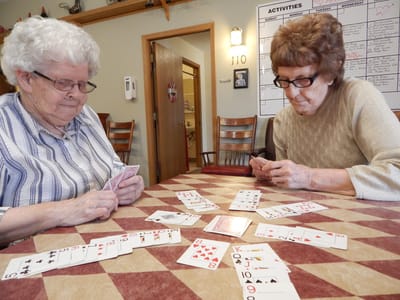 Residents playing cards in a shared activity space