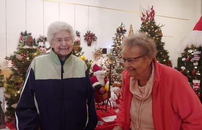 Two residents enjoying a festive indoor activity
