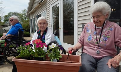 Residents planting flowers in a garden area