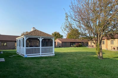 A gazebo in the outdoor space of a senior living facility