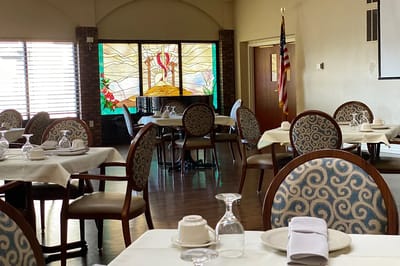 Dining area with tables and stained glass windows