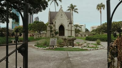 Exterior view of a chapel surrounded by gardens