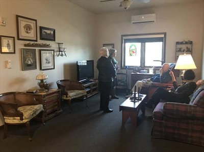 Residents interacting in a cozy living room setting