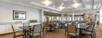 Bright dining room with tables set for residents