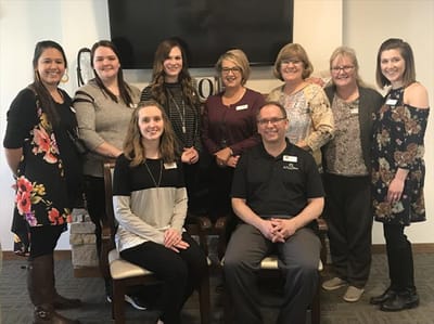 Staff members posing in a common area