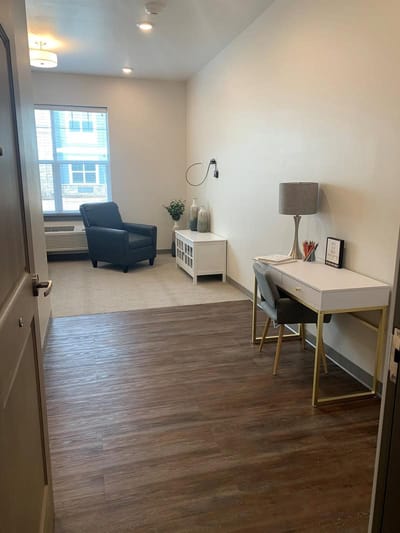 Interior view of a private resident room with furniture