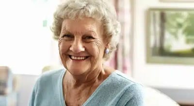 Smiling elderly woman in a cozy indoor setting