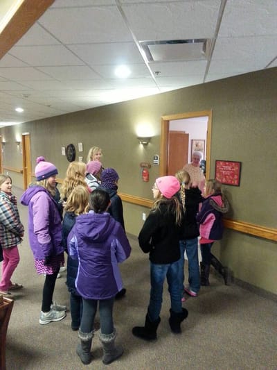 Children visiting a senior living facility interior