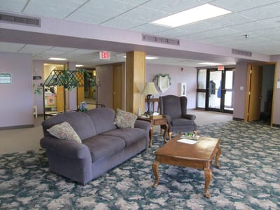 Common area with seating and decor in a senior living facility