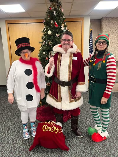 Staff and residents celebrating Christmas in festive costumes