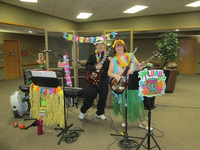 Residents enjoying live music at a luau party