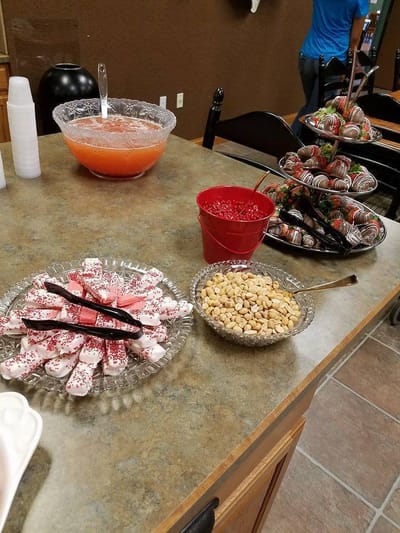 A table with holiday-themed snacks and drinks