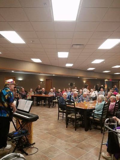 Residents enjoying live music in a common area.