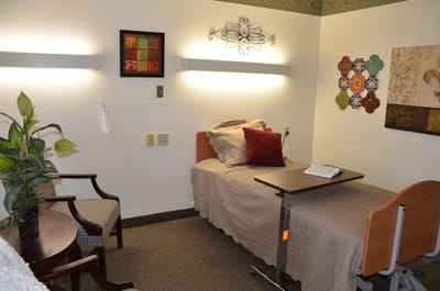 Cozy private resident room with bed and chair