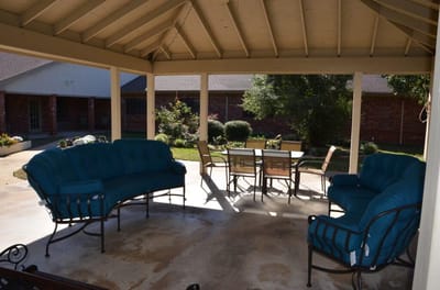 Outdoor seating area with blue couches and table