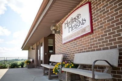 Exterior view of a senior living facility with signage