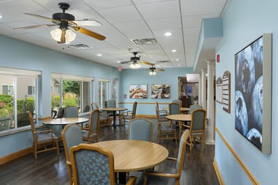 Dining area with tables and chairs in a bright interior