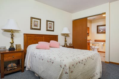 Cozy resident bedroom with floral bedding and lamps