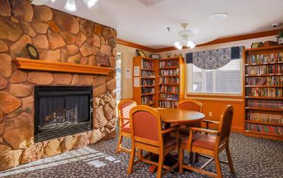 Cozy common area with bookshelves and fireplace