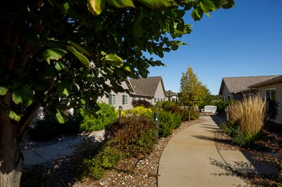 Pathway through landscaped outdoor space at a senior living facility