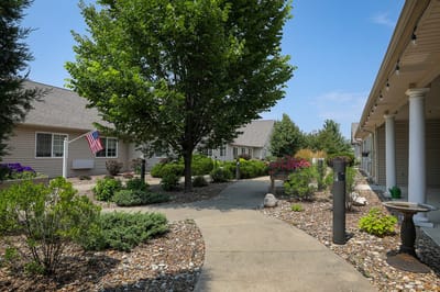 Pathway through landscaped outdoor space with an American flag