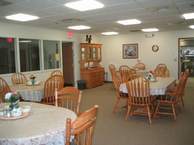 Dining area with tables and chairs set for meals