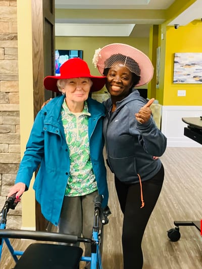Resident and staff member smiling in a common area