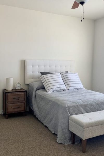 Cozy senior living bedroom with a bed and nightstand