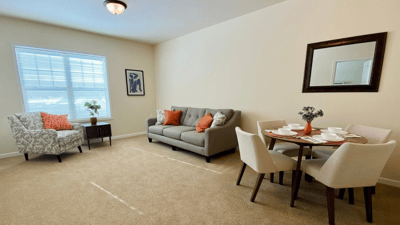 Cozy interior of a resident's room with seating and dining area