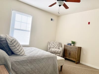 Cozy resident room with a bed and chair