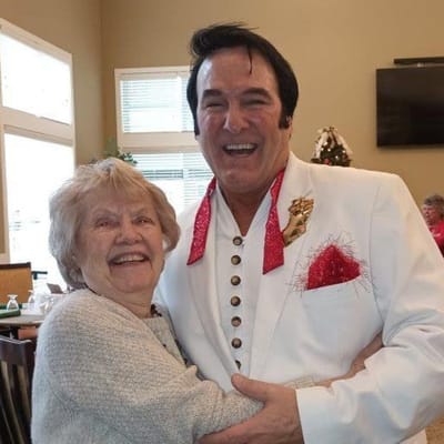 Resident enjoying a celebration with an entertainer