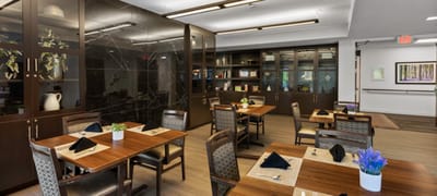 Dining room with wooden tables and plants