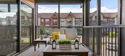 Cozy seating area on a balcony overlooking landscaping