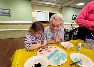 Two women engaging in a painting activity together