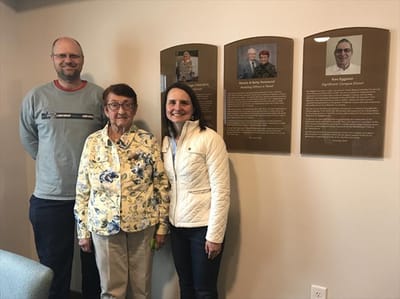 Residents and staff gathered near a recognition wall