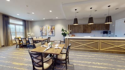 Bright dining area with tables and kitchen counter