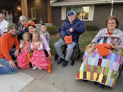 Residents and children celebrating Halloween together
