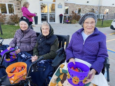 Three residents enjoying a Halloween event outdoors
