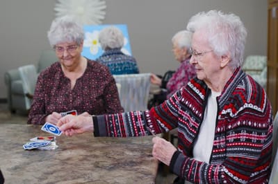 Residents playing cards in an activity room