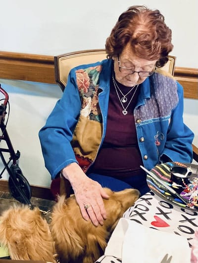Resident interacting with a dog in a communal area