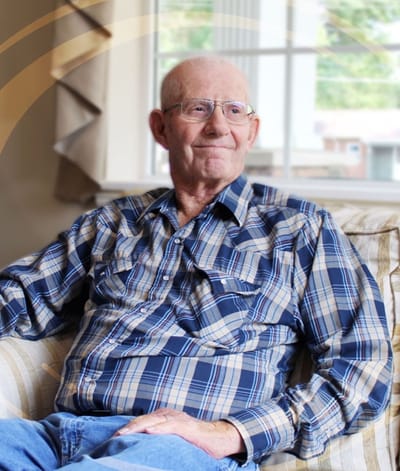 Senior man sitting comfortably in a living room
