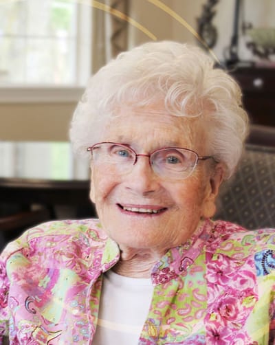 Elderly resident smiling in a colorful blouse