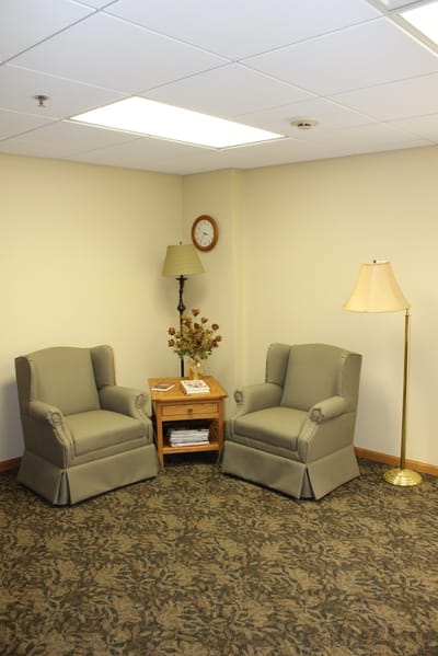 Seating area with two chairs and a lamp