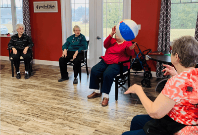 Residents playing with a beach ball in a common area