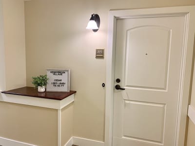 Resident room door with a number and plant decoration
