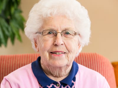 Smiling elderly woman in a common area